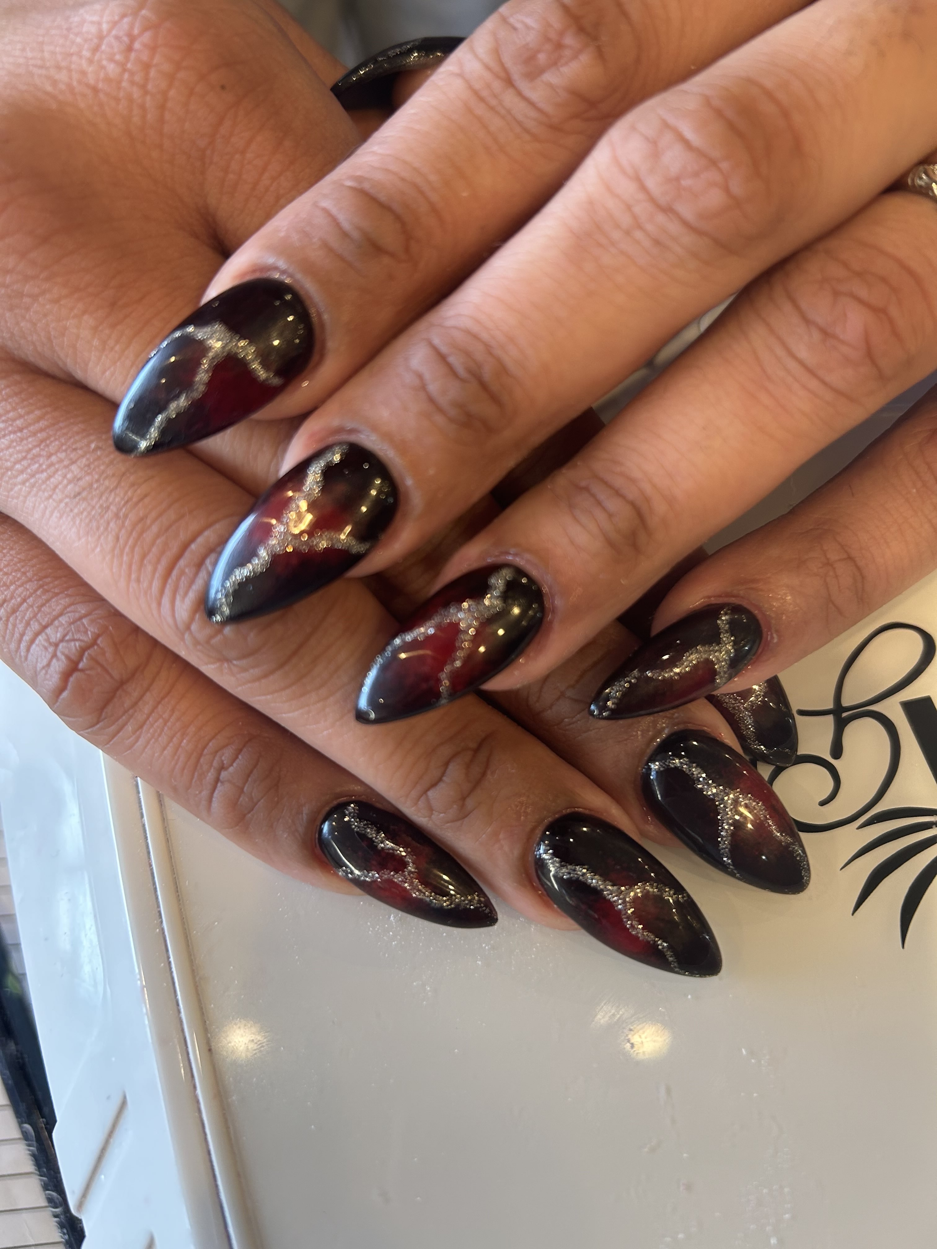 Red and Black with Gold and Silver Accent Sparkles Red Radial Ombre Almond Nail Art Design